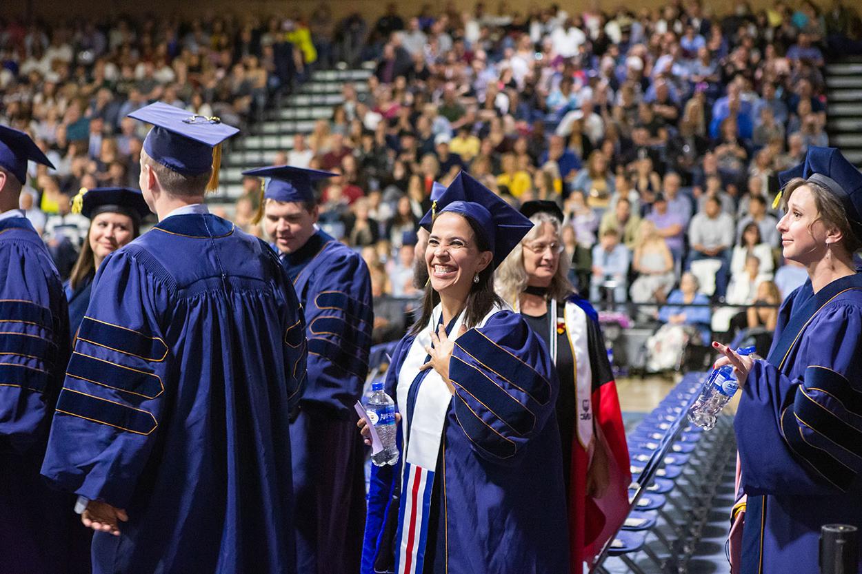 Doctoral Student smiles during commencement